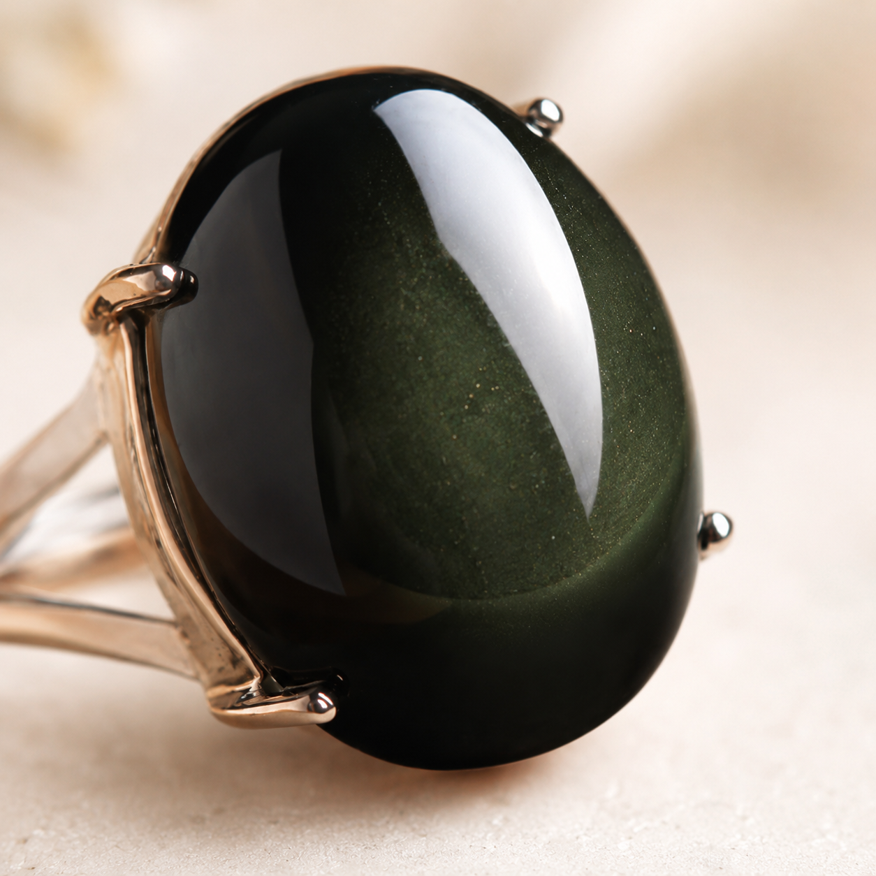Close-up of the rainbow obsidian ring and its blue shimmer
