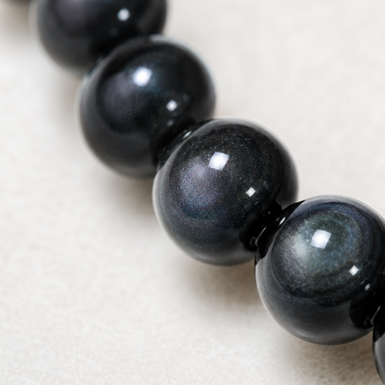 Detail of natural rainbow obsidian beads