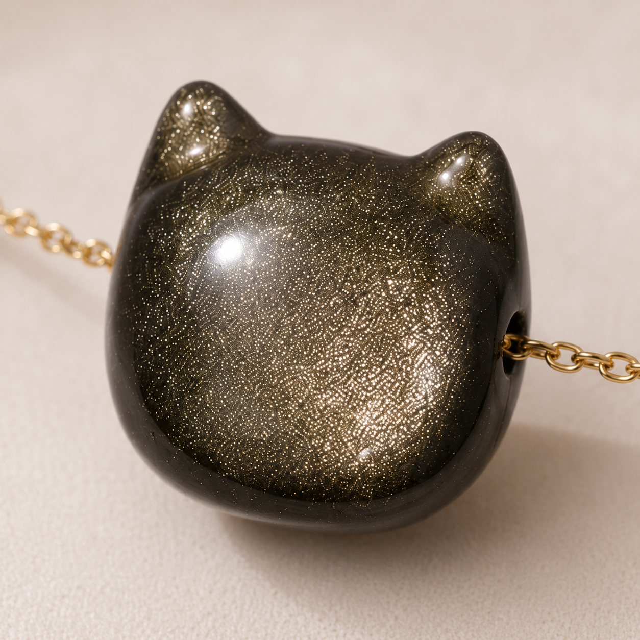 Close-up of the gold sheen obsidian pendant and its golden shimmer