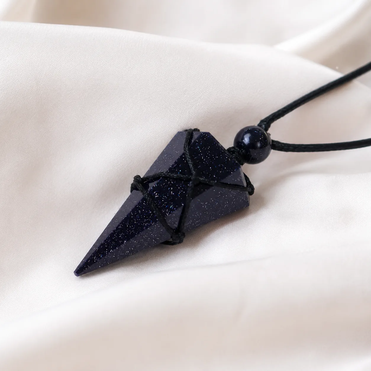 Black obsidian pendant worn around the neck