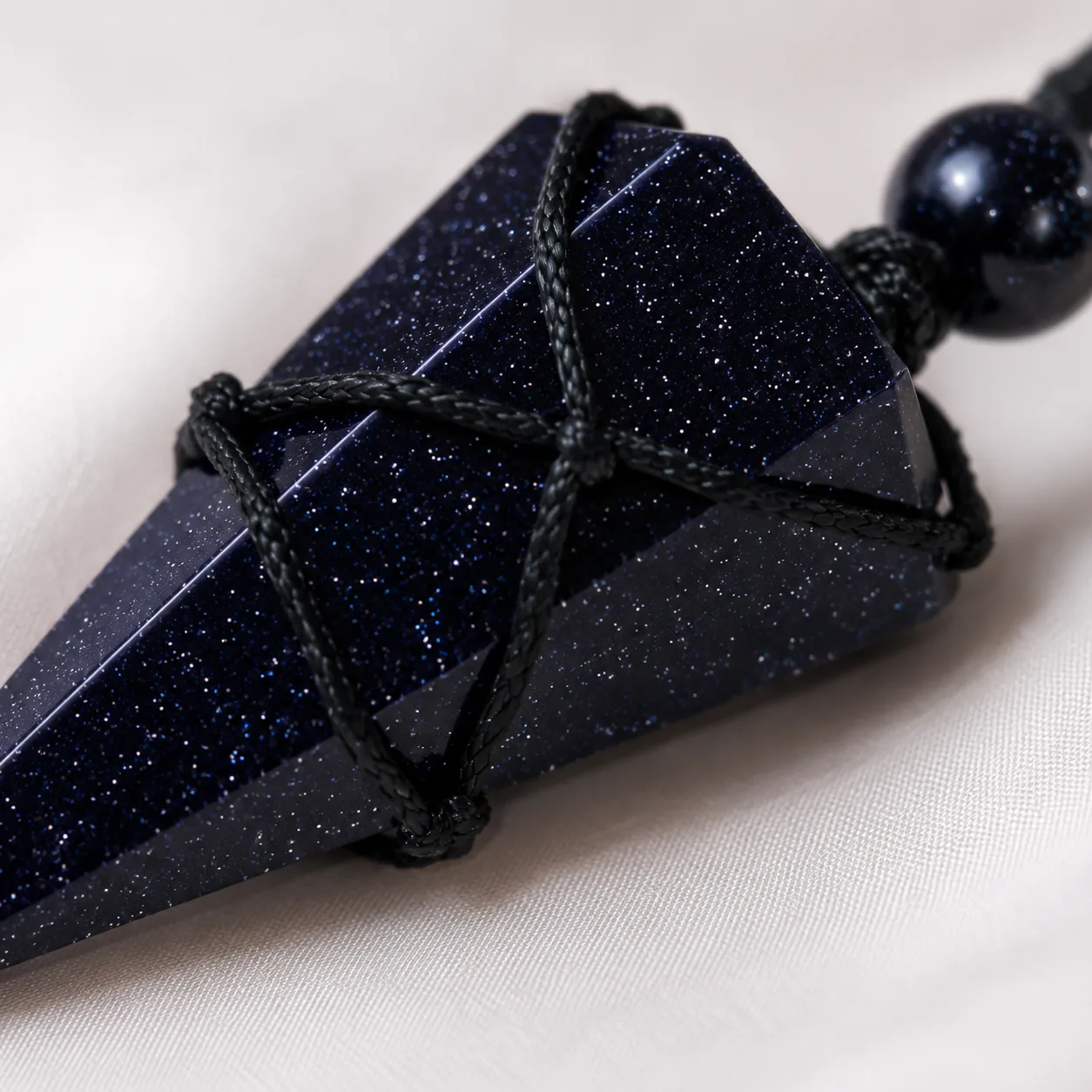 Close-up of the black obsidian pendant and its cord
