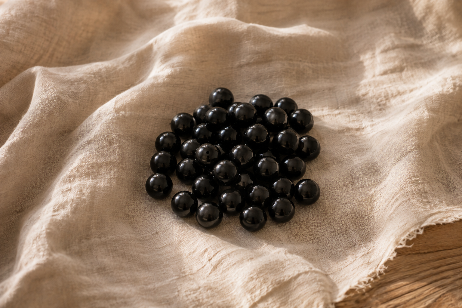 Perles d obsidienne noire polie sur lin clair