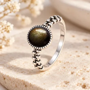 Bague en argent à épaules de billes graduées, cabochon rond d'obsidienne dorée