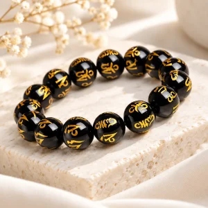 Bracelet mantra obsidienne 12 mm, perles gravées des six syllabes tibétaines rehaussées d'or