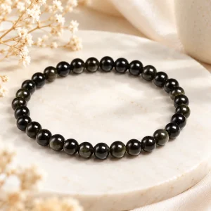 Bracelet obsidienne dorée 8 mm, perles au reflet cuivré contrasté sur fil élastique