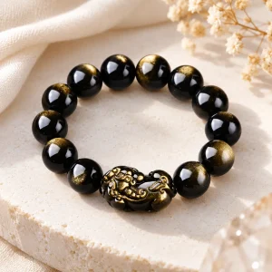 Bracelet Pixiu obsidienne dorée 12 mm, créature sculptée dans la pierre et rehaussée d'or