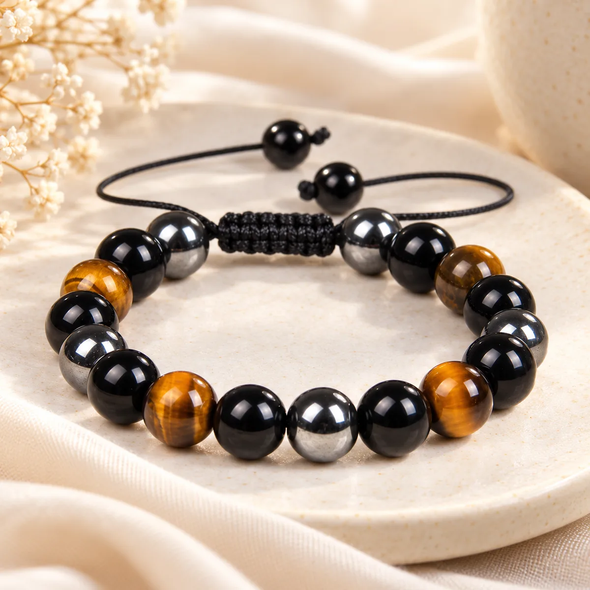 Bracelet triple protection ajustable Bracelet triple protection ajustable, perles d'obsidienne, d'hématite et d'œil de tigre sur nœud coulissant