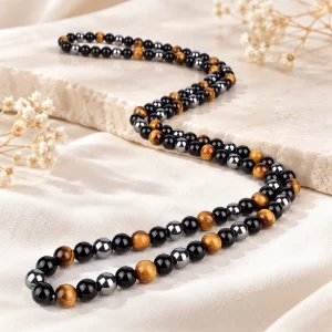Collier long alternant perles d'obsidienne, d'œil de tigre et d'hématite